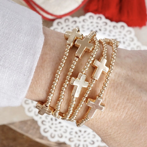 Stretchy gold tone cross beaded bracelet
